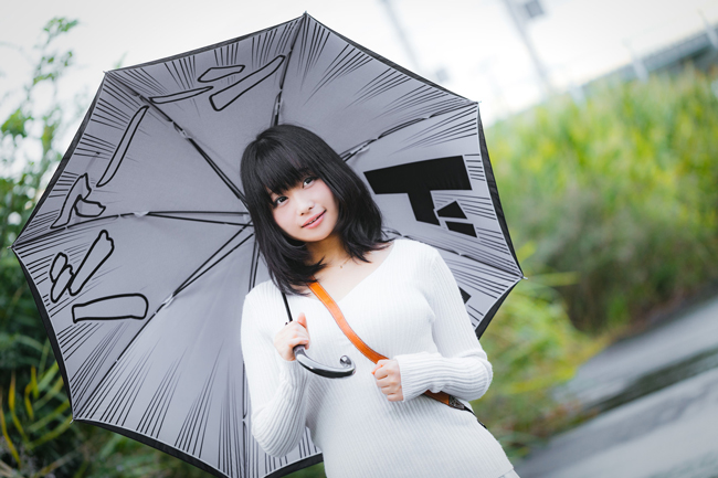 Japanese girl, with katakana-print umbrella.