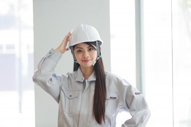 Female construction worker wearing a helmet.
