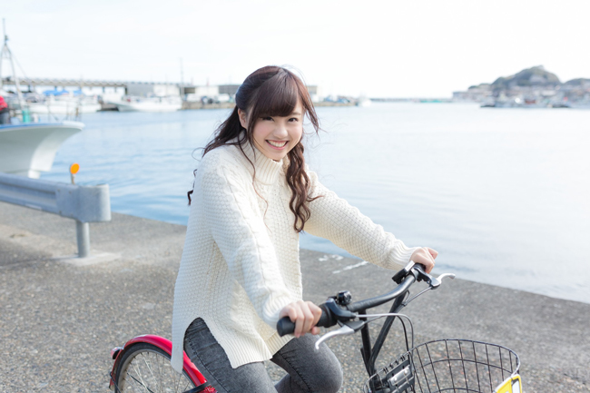 Smiling girl on bike.
