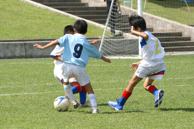 Kids playing soccer.