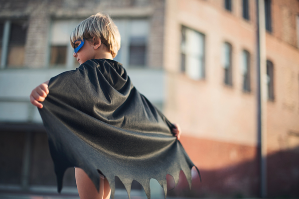 Kid in batman costume realizing his dream.